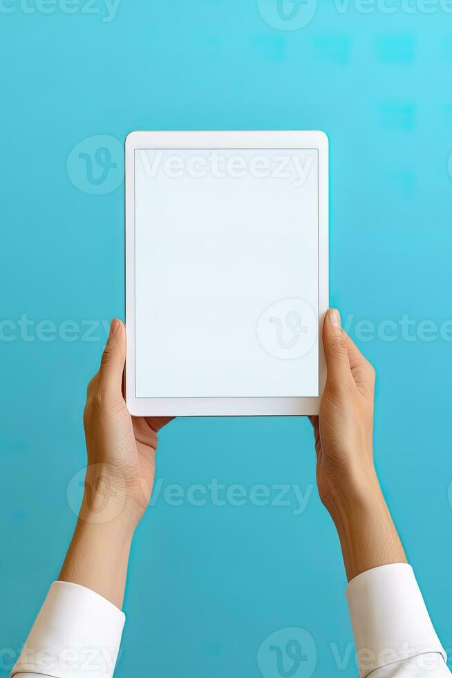 Hand holding tablet with mockup blank screen isolated on blue background. ai generated photo