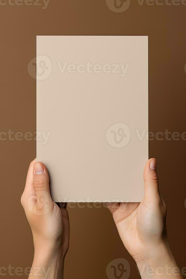 A human hand holding a blank sheet of white paper or card isolated on brown background. ai generated photo