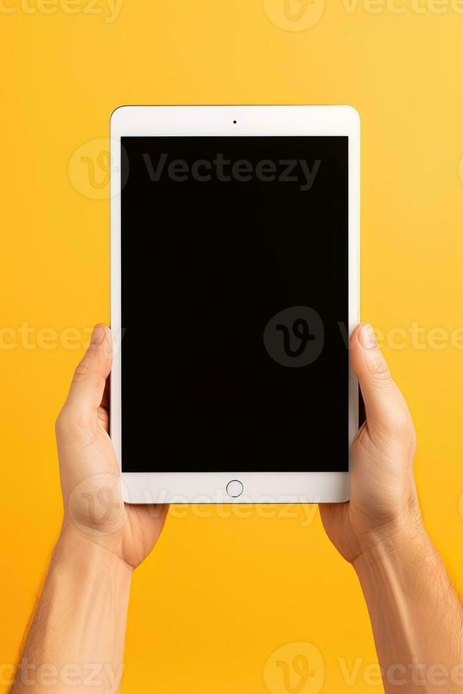 Hand holding tablet with mockup blank screen isolated on yellow background. ai generated photo