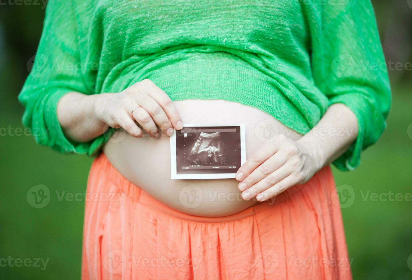 Pregnant woman with ultrasound image of a baby photo