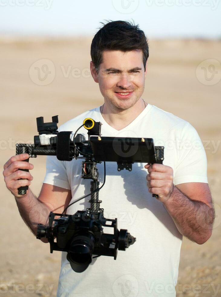 Smiling man with steadicam equipment outdoor photo