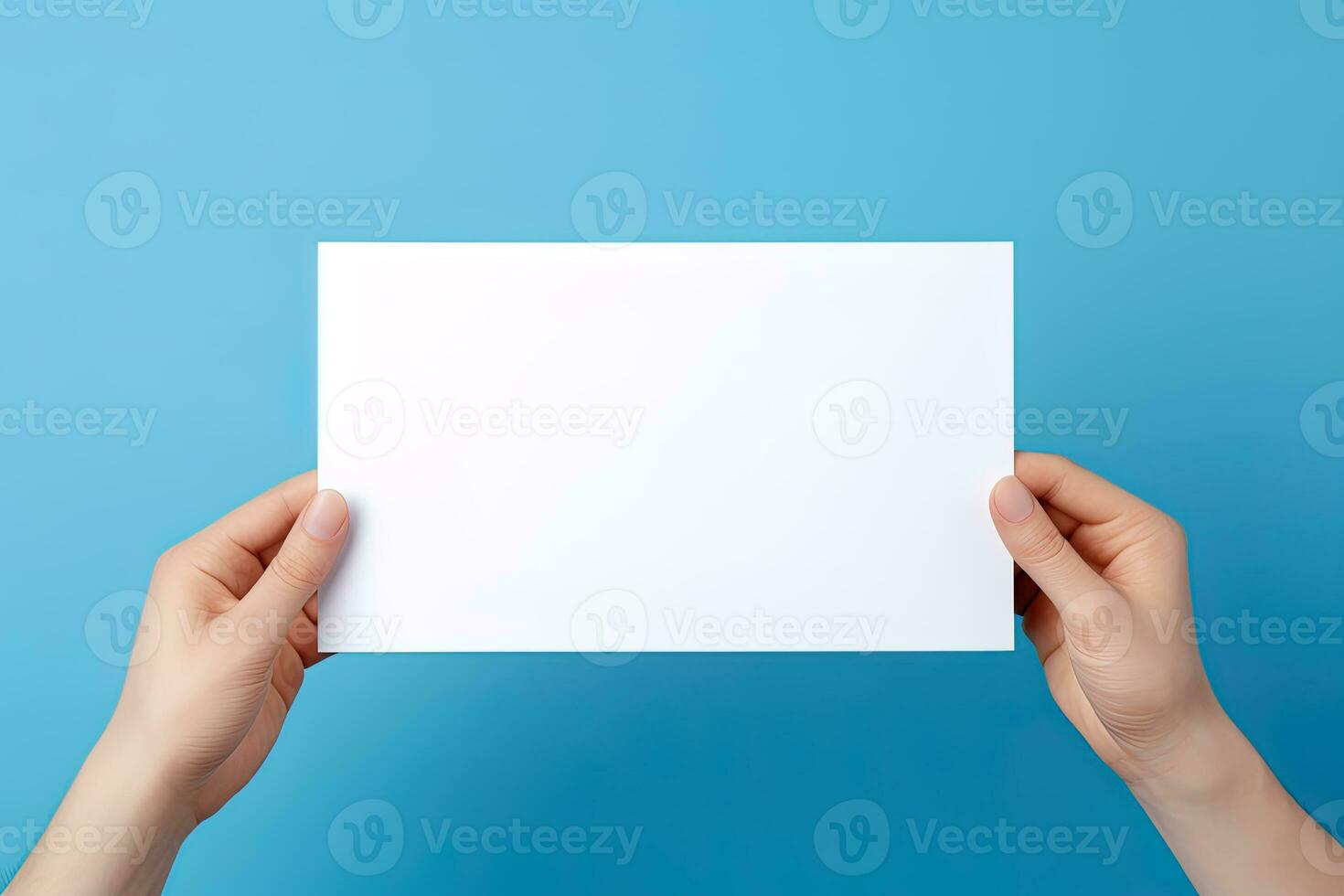 A human hand holding a blank sheet of white paper or card isolated on blue background. ai generated photo