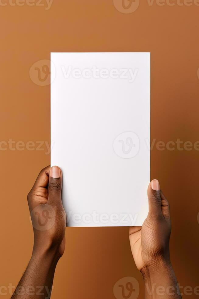 A human hand holding a blank sheet of white paper or card isolated on brown background. ai generated photo