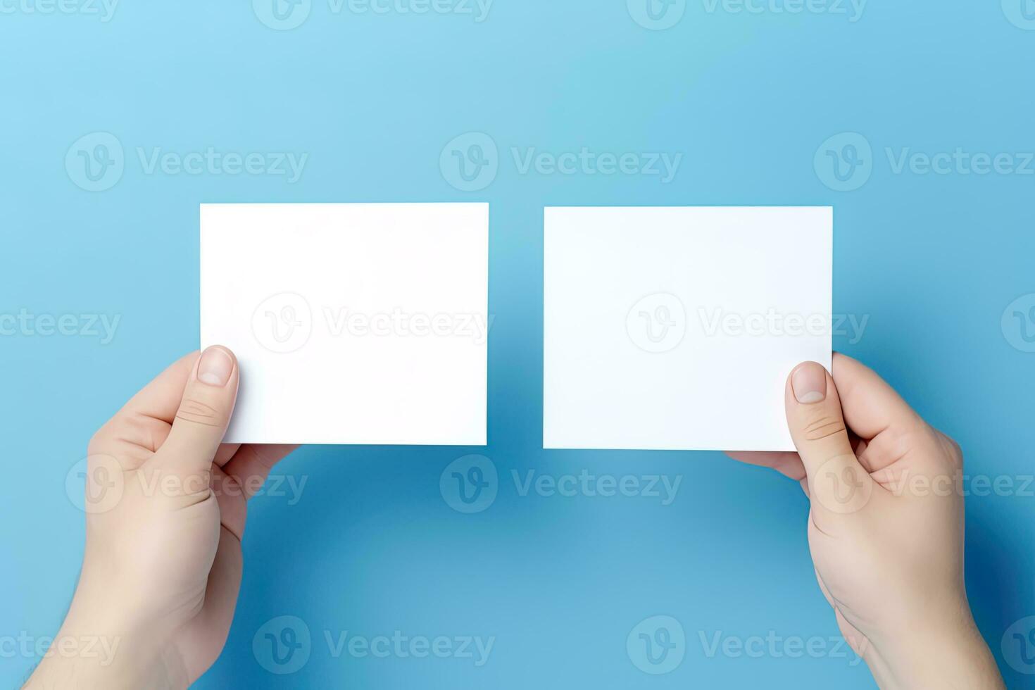 A human hand holding a blank sheet of white paper or card isolated on blue background. ai generated photo