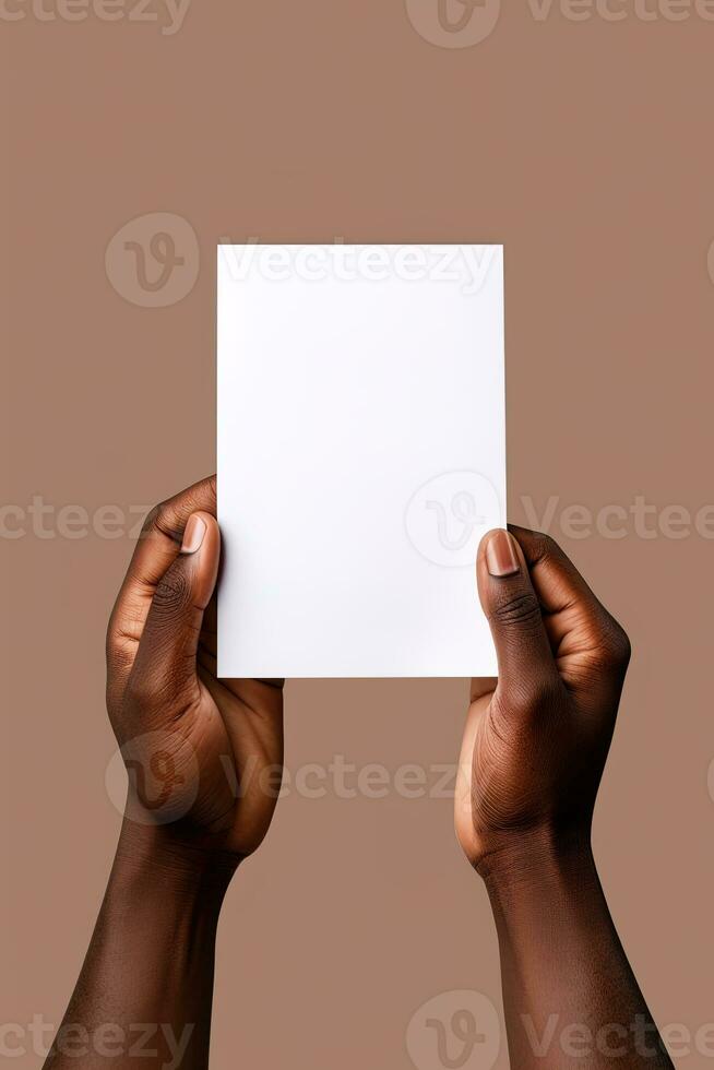 A human hand holding a blank sheet of white paper or card isolated on brown background. ai generated photo