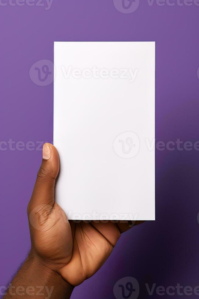A human hand holding a blank sheet of white paper or card isolated on purple background. ai generated photo