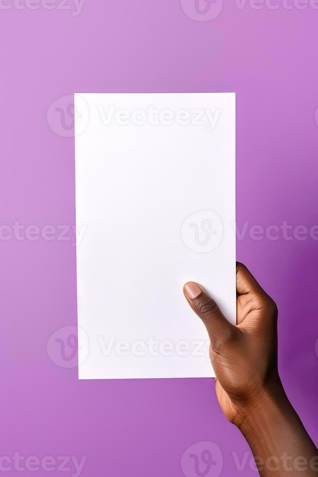 A human hand holding a blank sheet of white paper or card isolated on purple background. ai generated photo