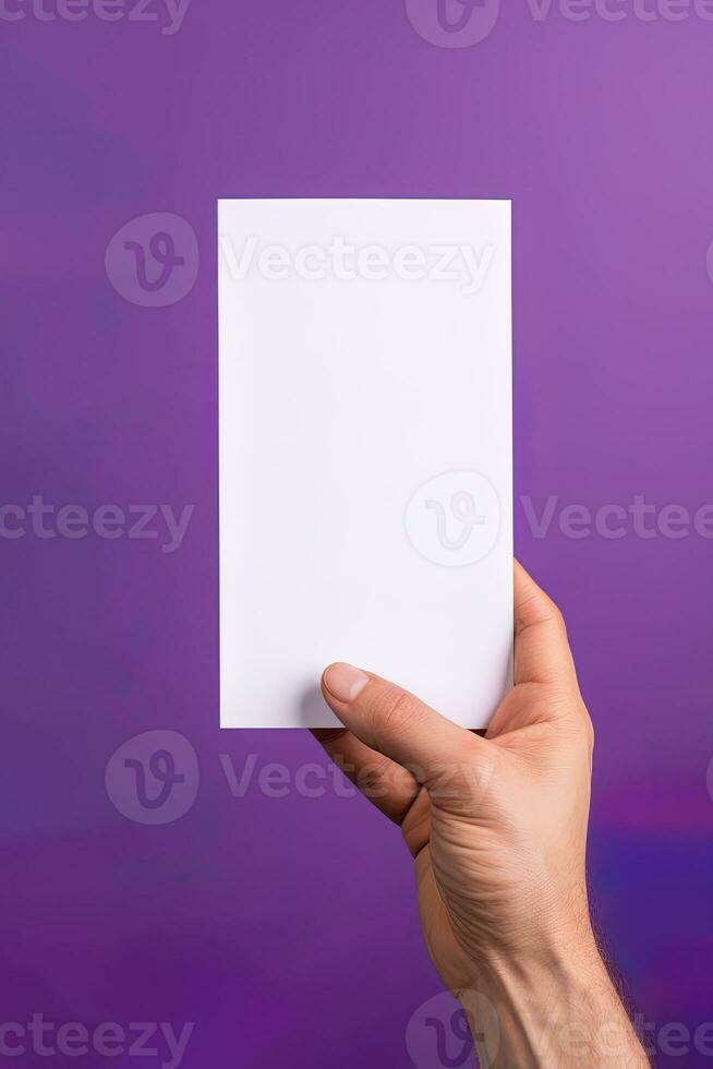 A human hand holding a blank sheet of white paper or card isolated on purple background. ai generated photo