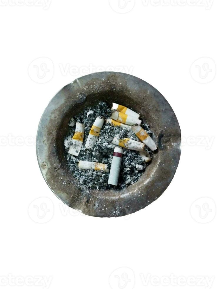 image of an iron ashtray full of cigarette butts and cigarette ashes on a white background photo