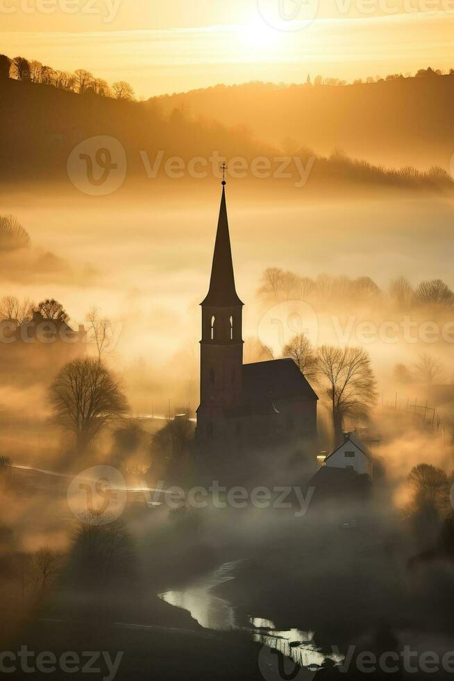 Silhouette of church in misty village landscape viewed from above photo