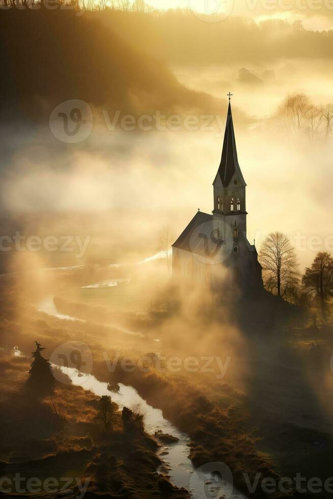 Silhouette of church in misty village landscape viewed from above photo