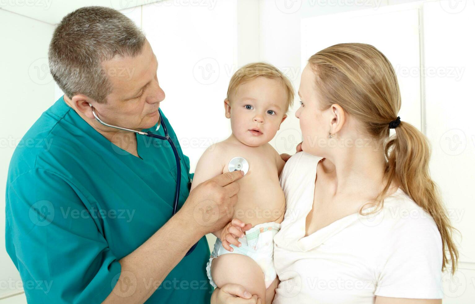 Pediatrician examining child photo