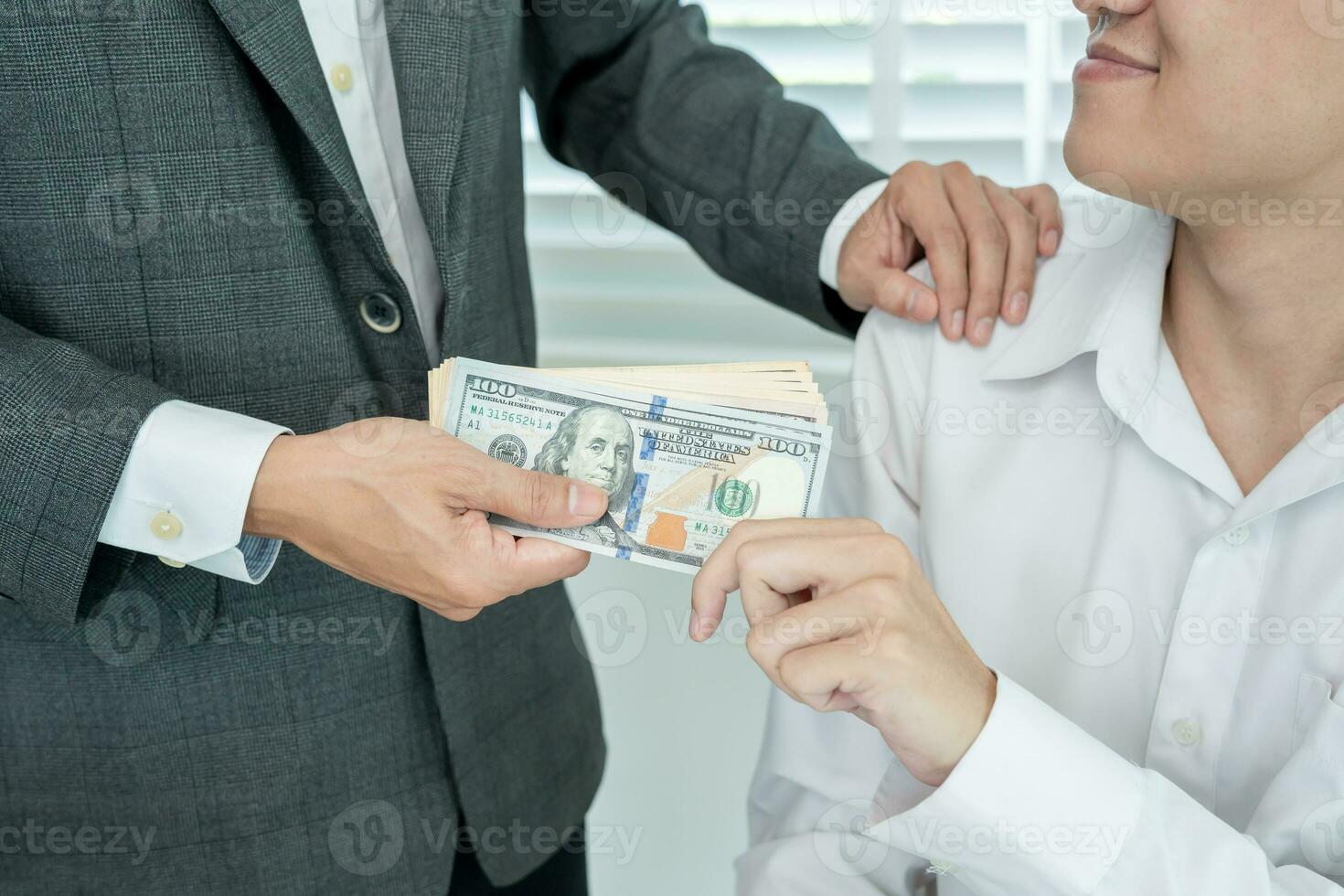 Businessmen receive salary or bonuses from management or Boss. Company give rewards to encourage work. Smiling businessman enjoying a reward at the desk in the office. photo