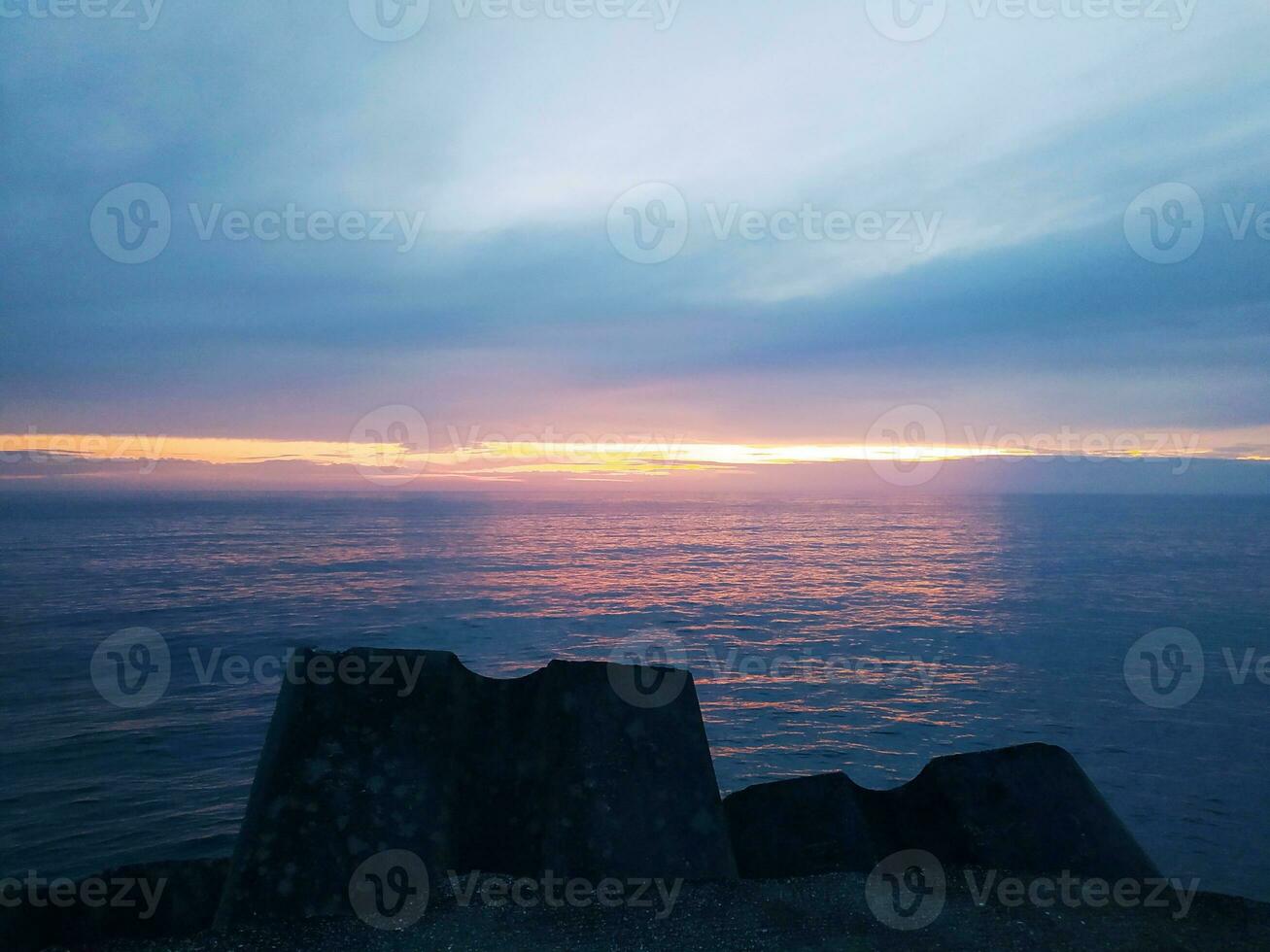 Beautiful sunset at the sea, amazing colors, light beam shining photo