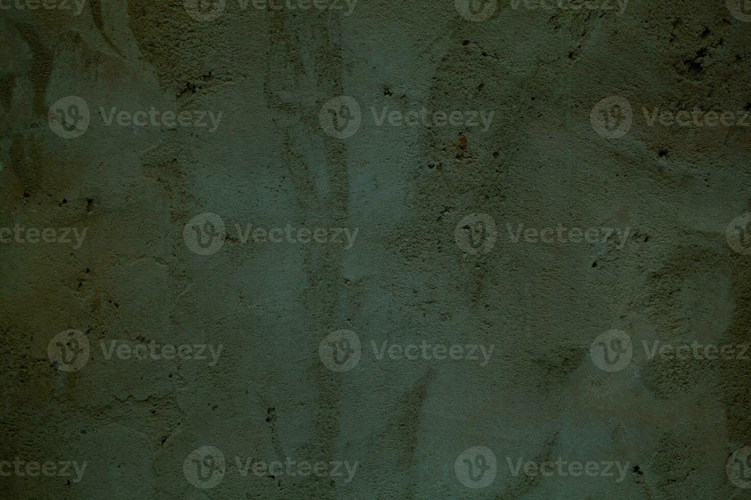 Grungy dark green wall with faded paint photo