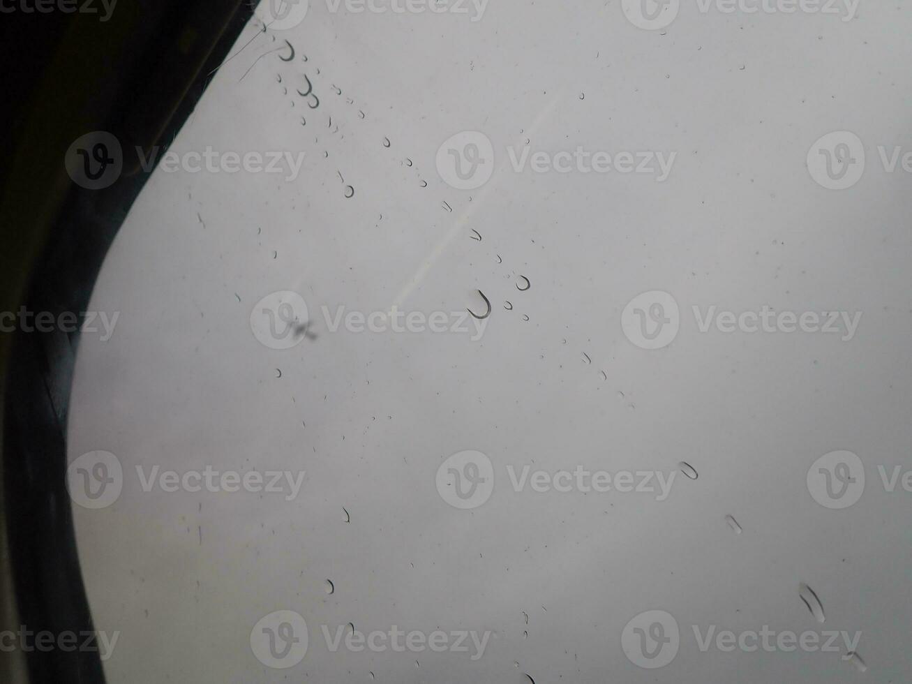 Car window with rain streaks photo