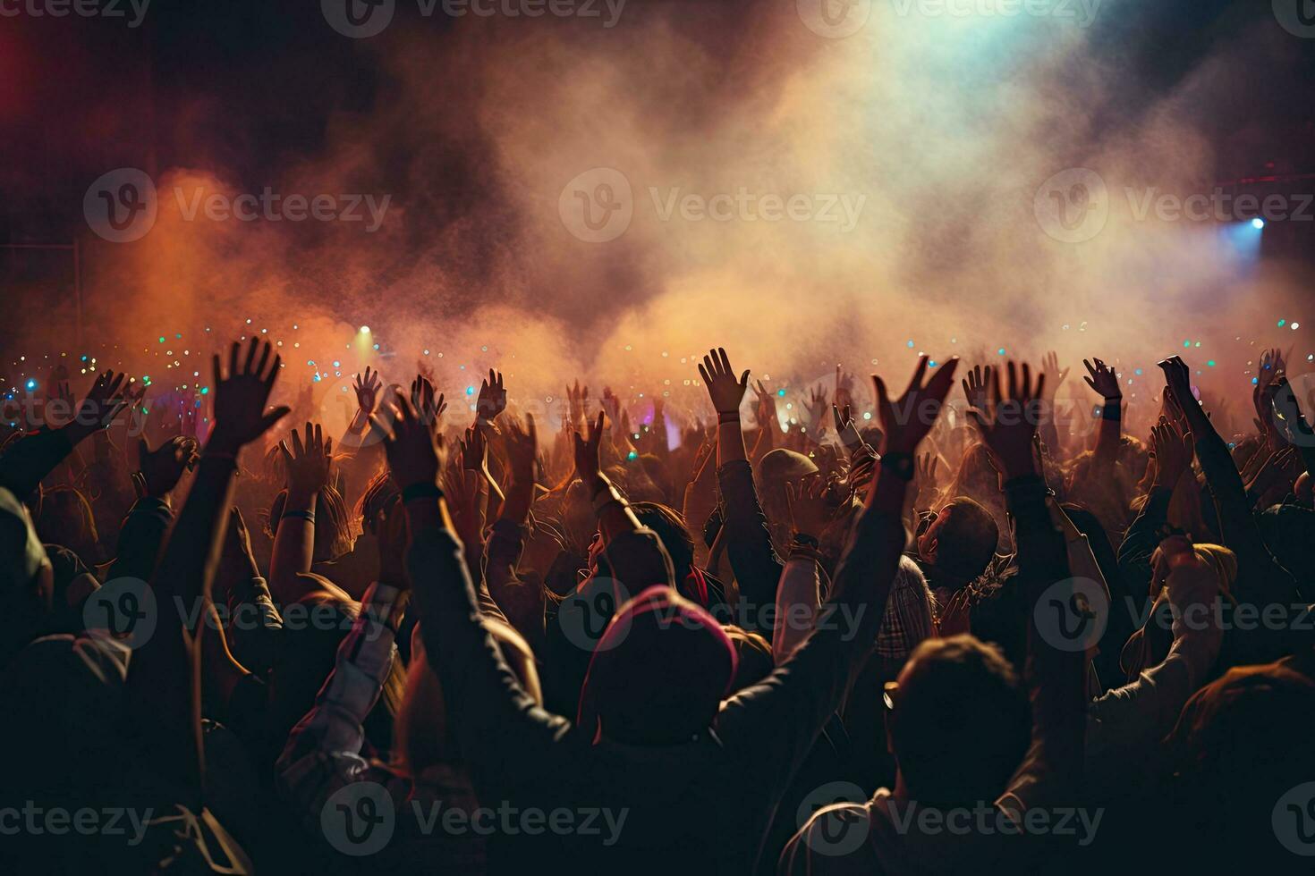 Crowd cheering at a music festival and raising hands in the air photo