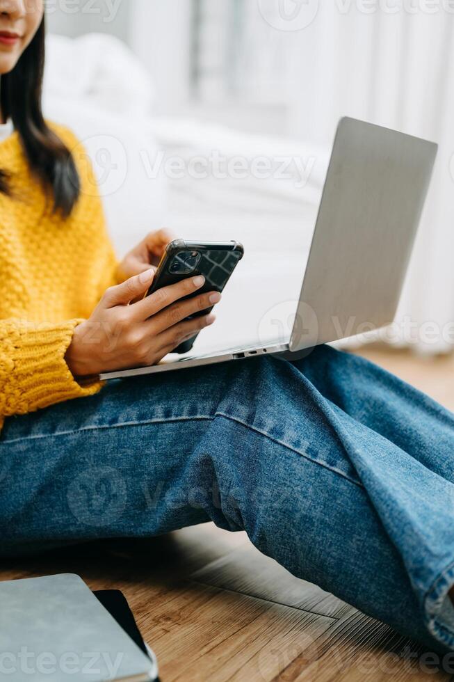 Woman using smart phone for mobile payments online shopping, omni channel, sitting on table, virtual icons photo