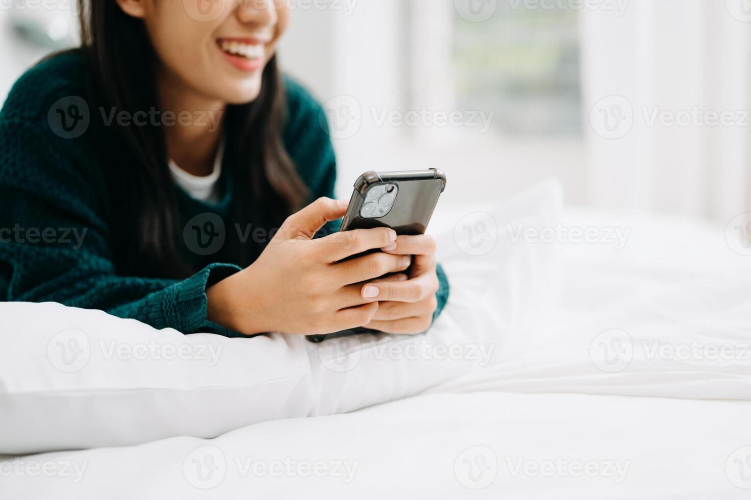 Woman using smart phone for mobile payments online shopping, omni channel, sitting on table, virtual icons photo