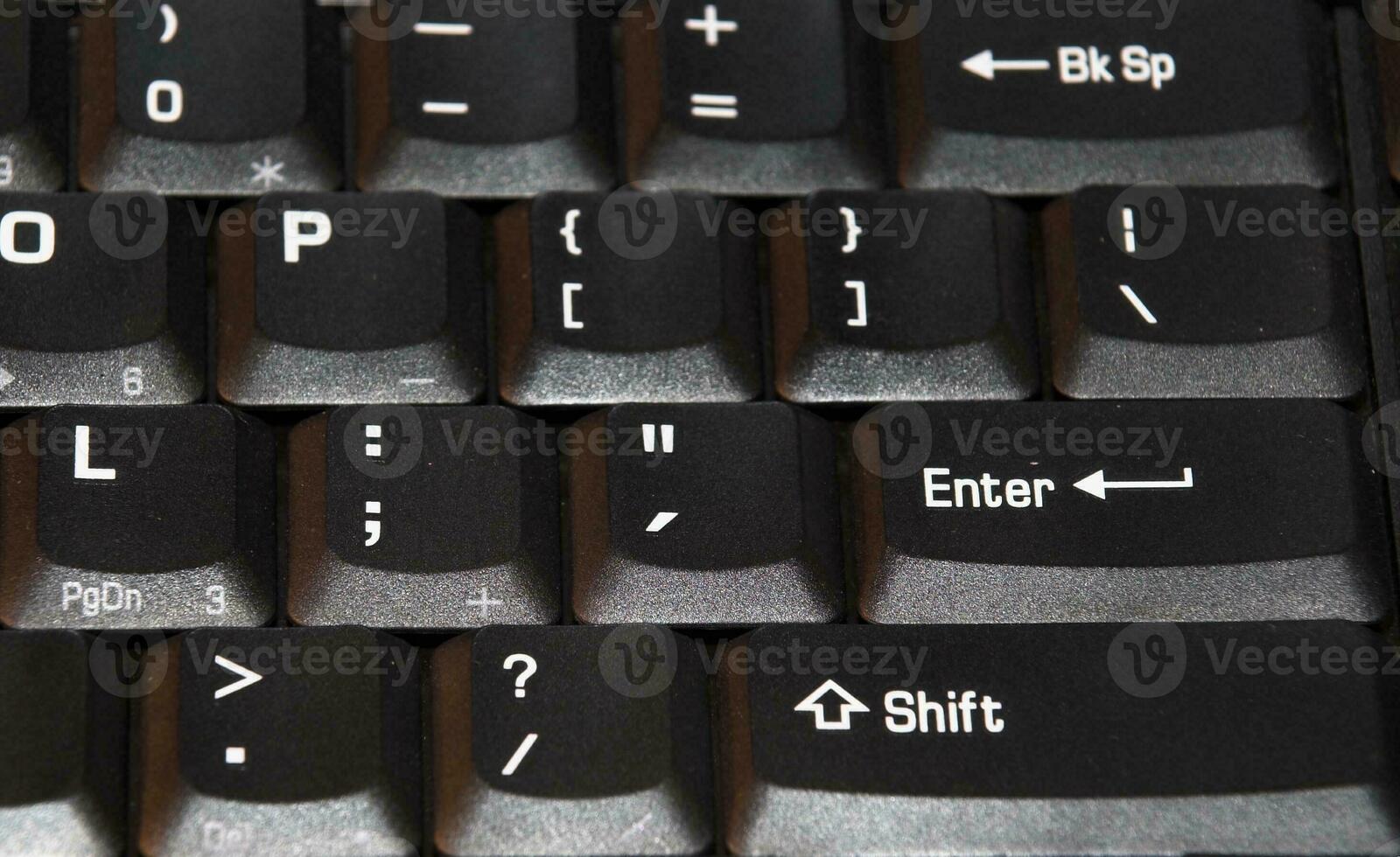 a black computer keyboard forming an IT background photo