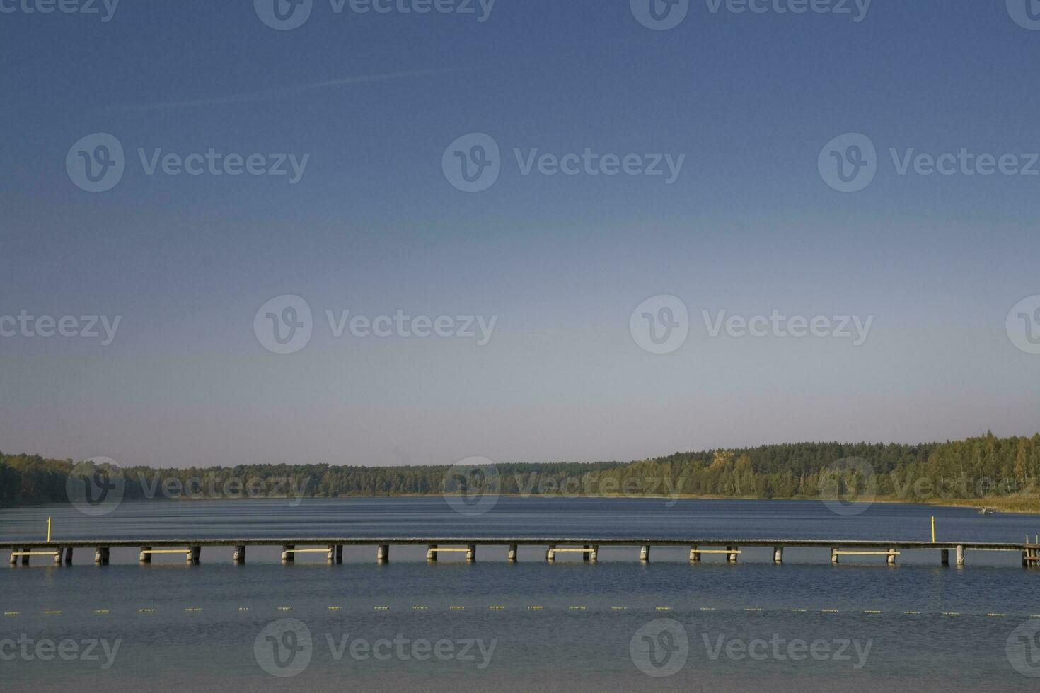 autumn landscape with trees, lake and blue sky in Poland in Europe photo