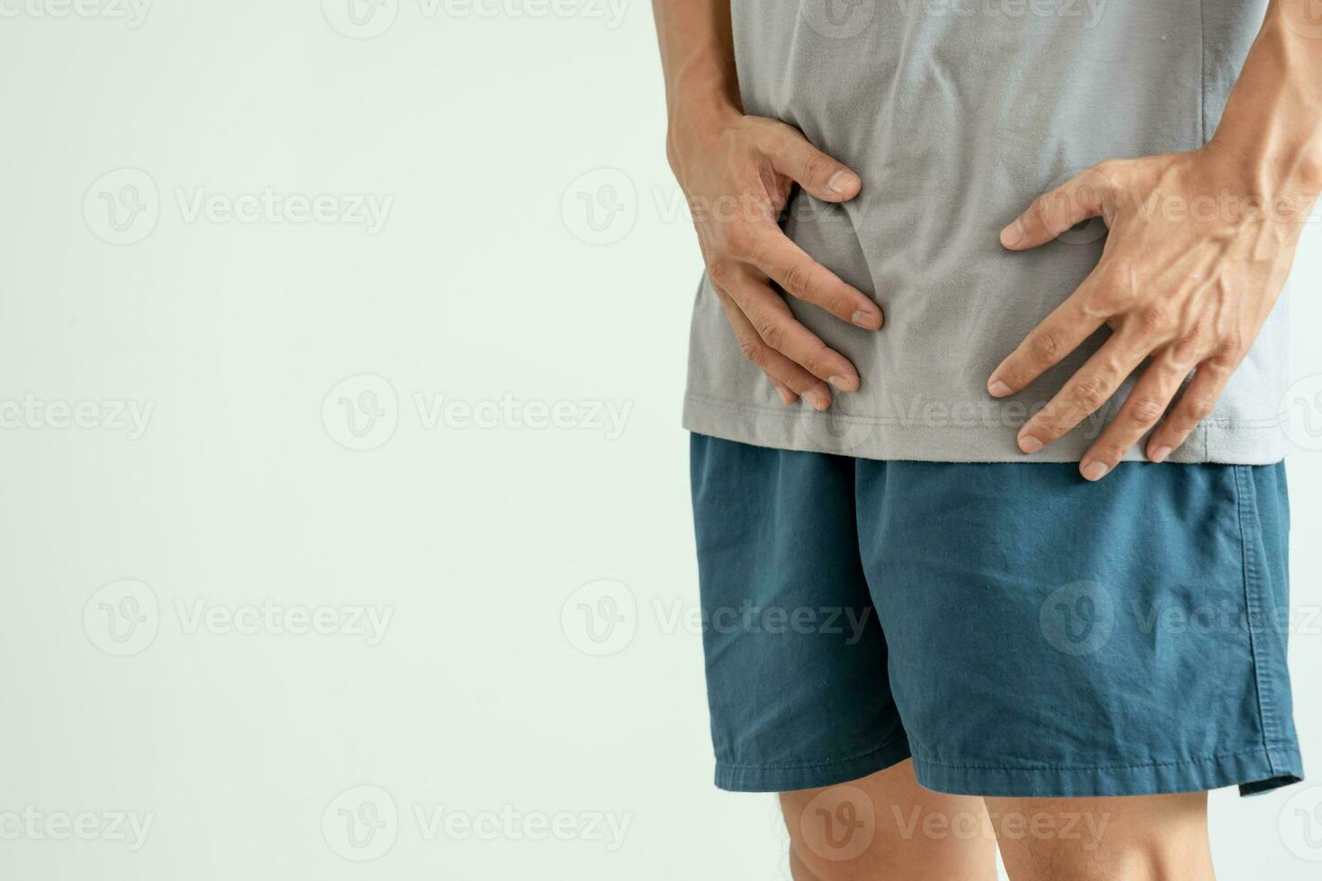 Man hold hand in front of private parts feeling discomfort from disease and inflammation. Venereal, testicular cancer. bladder problems, erectile dysfunction, premature ejaculation, prostate cancer photo