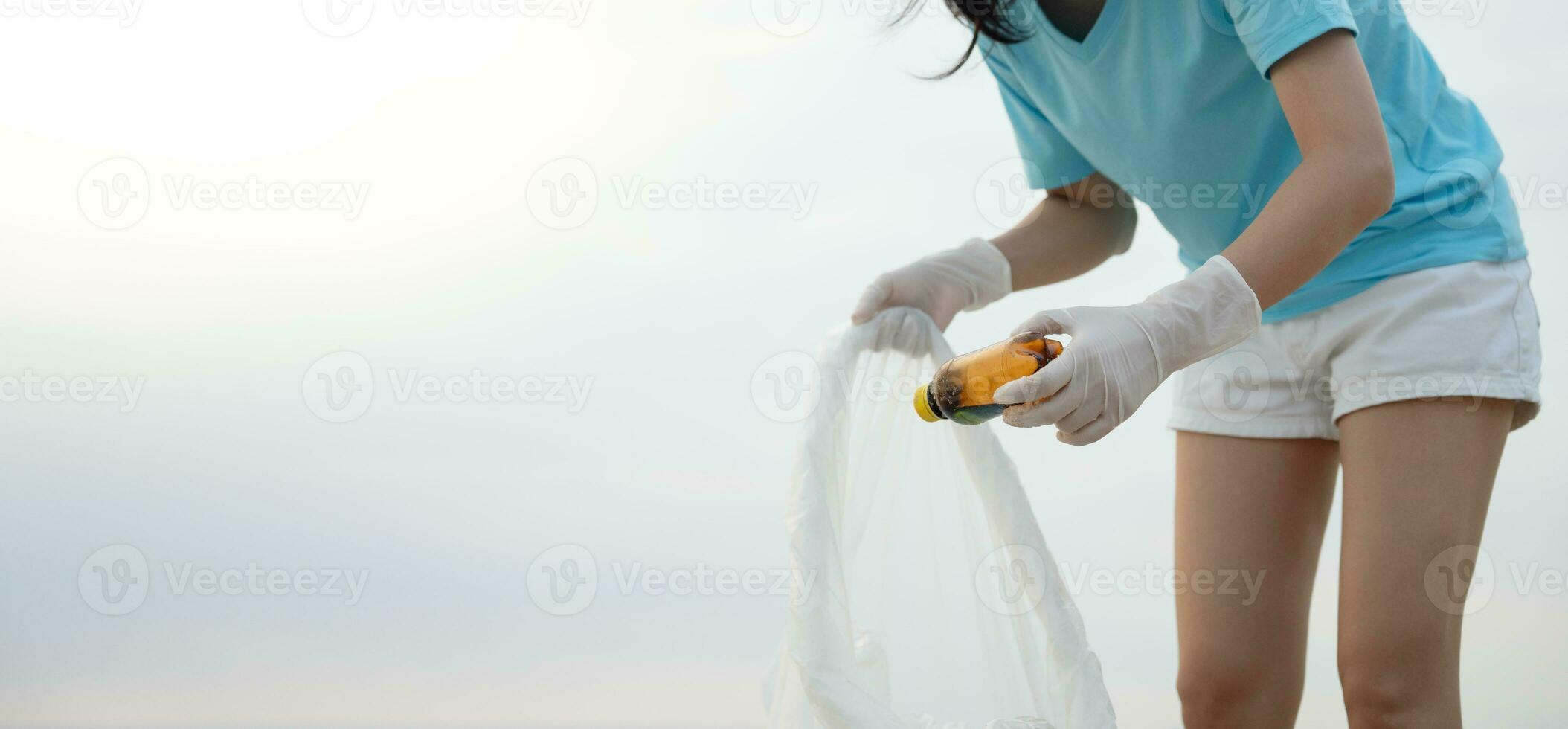 Save water. Volunteer pick up trash garbage at the beach and plastic bottles are difficult decompose prevent harm aquatic life. Earth, Environment, Greening planet, reduce global warming, Save world photo