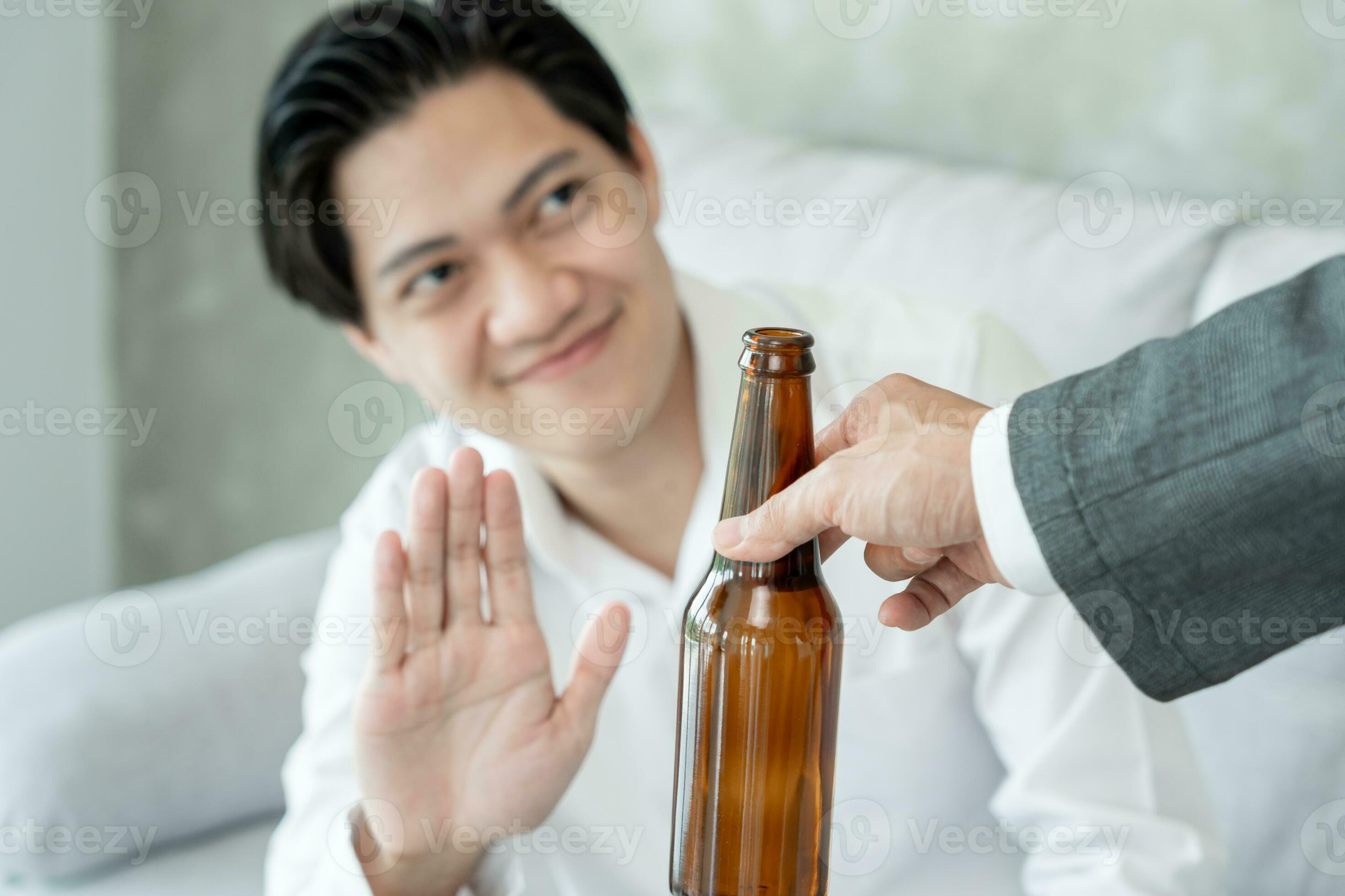 man smile and refuses say no and avoid to drink an alcohol hand show man smile and refuses say no and avoid to drink an alcohol hand show