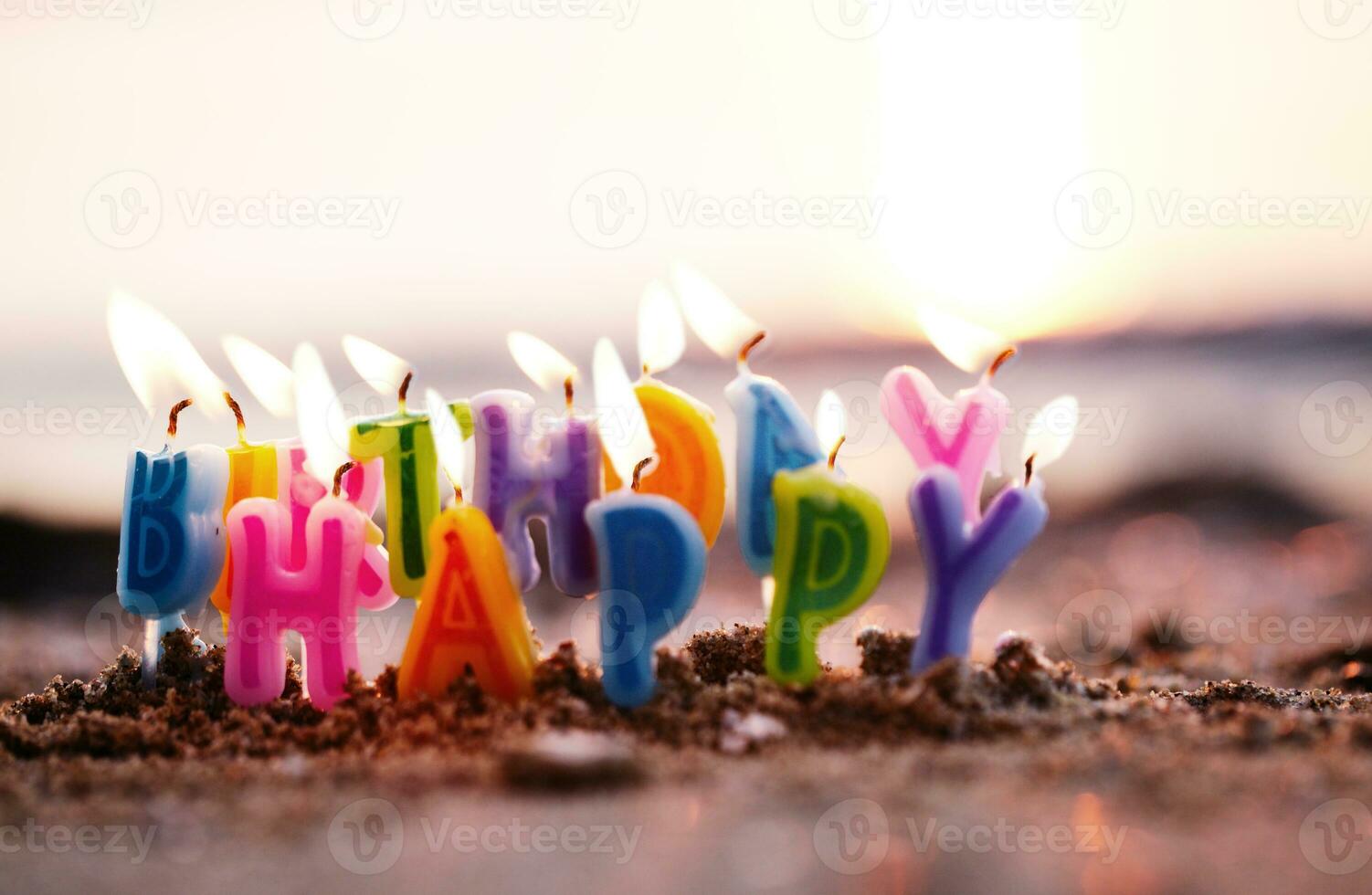 Birthday candles burning on a seashore photo