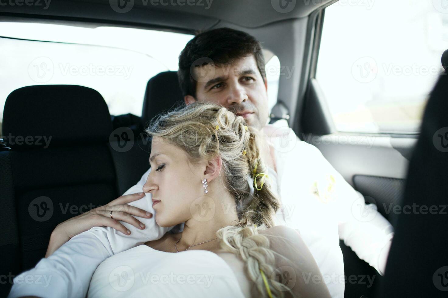 Woman sleeping on her husbands shoulder photo