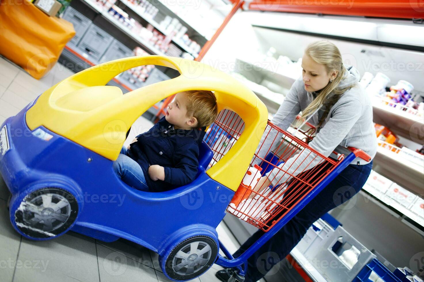 Young boy in a child friendly supermarket trolley photo