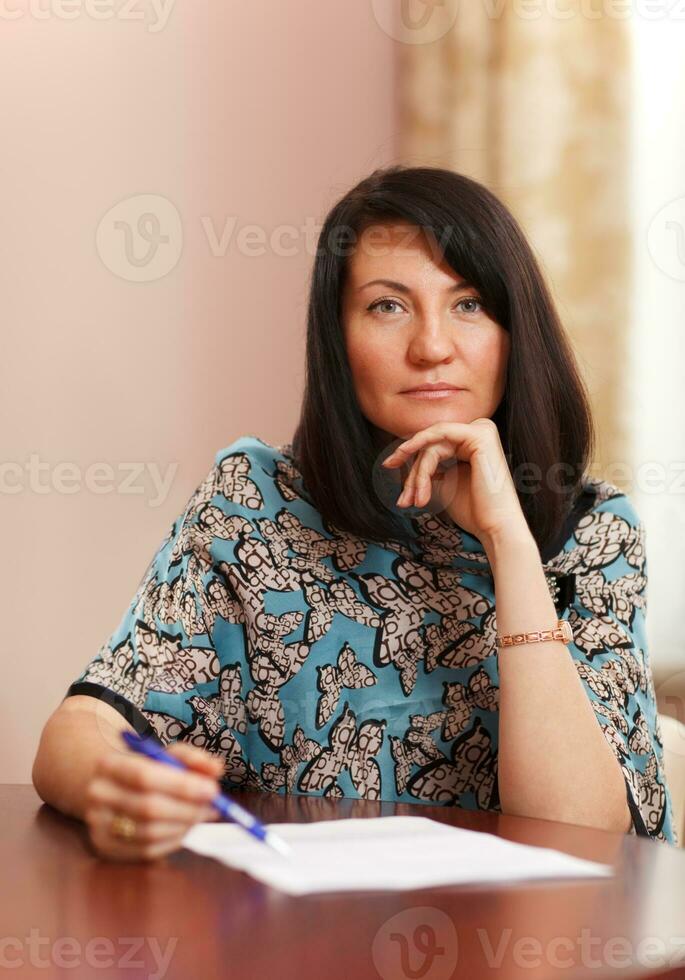 Attractive middle-aged woman working at home photo