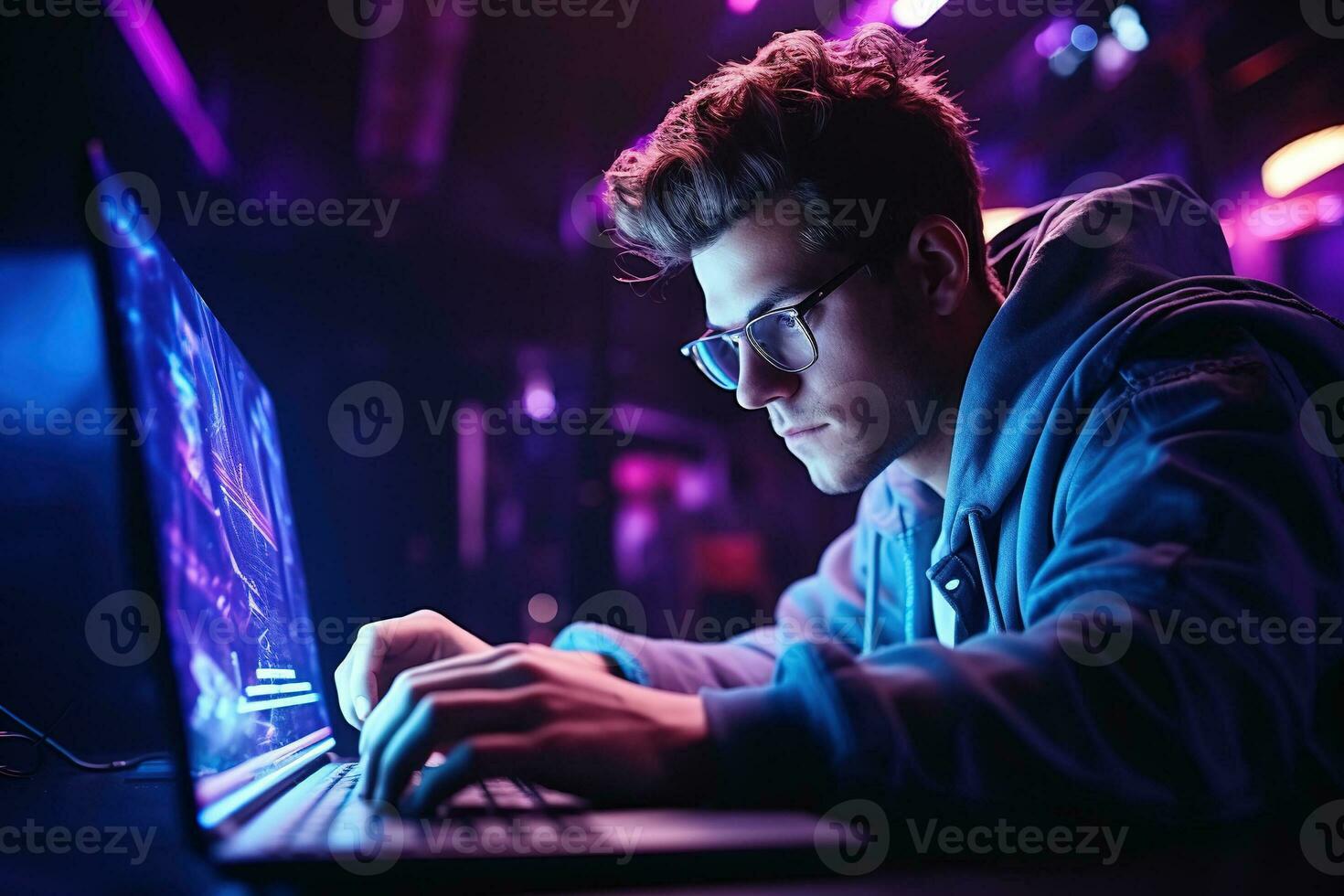 Man in glasses is sitting by the laptop in dark room with neon lighting. AI Generated photo