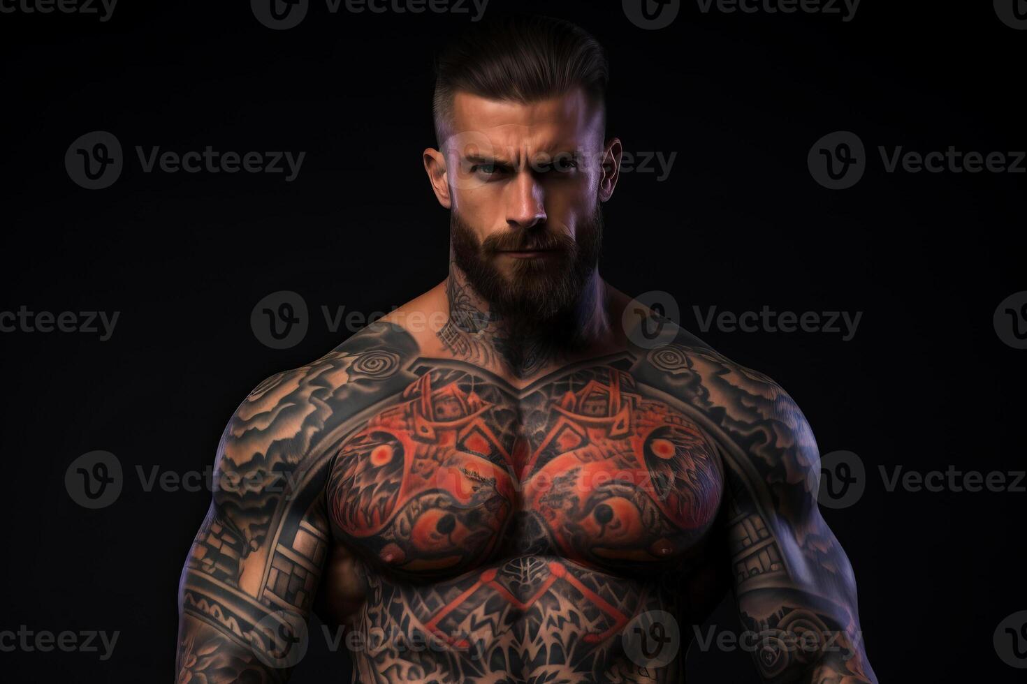Confident man with muscular body tattooed on black background. photo