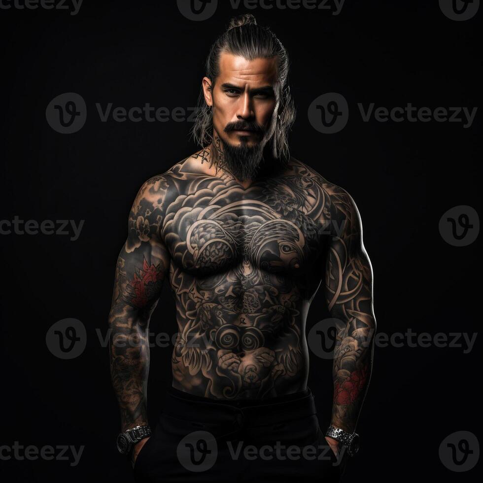 Confident man with muscular body tattooed on black background. photo
