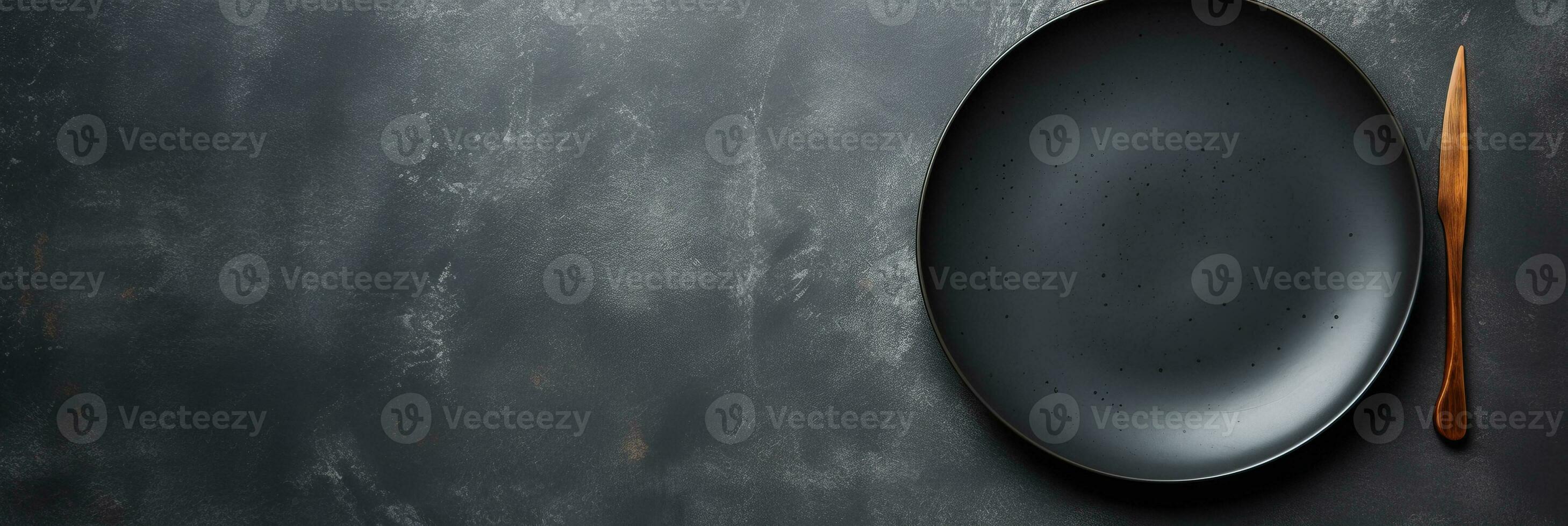 An empty black plate with cutlery on a dark concrete back. AI Generated photo