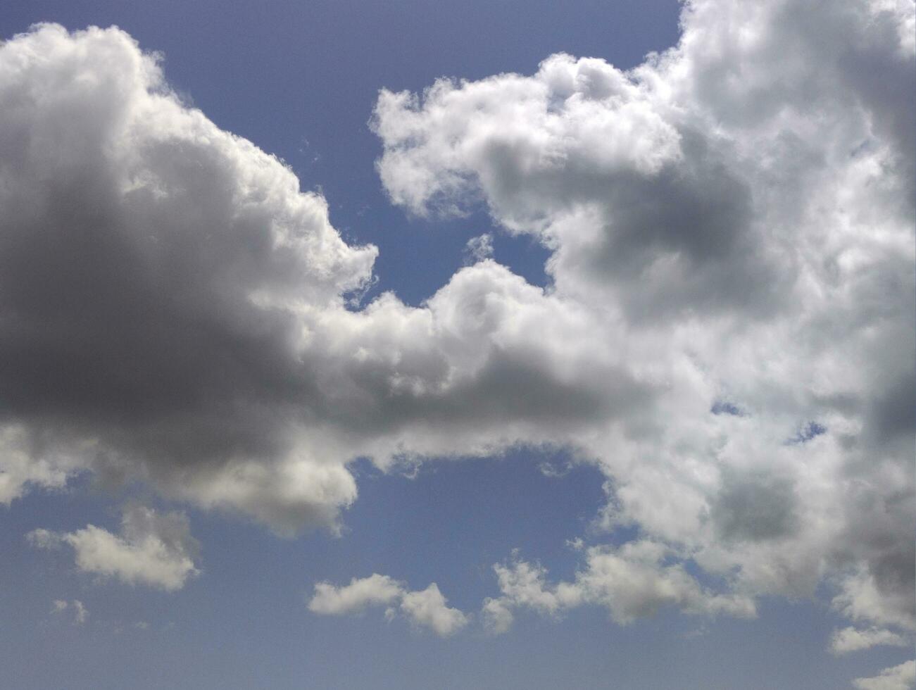 White clouds over blue sky background. Fluffy cumulus cloudscape photo