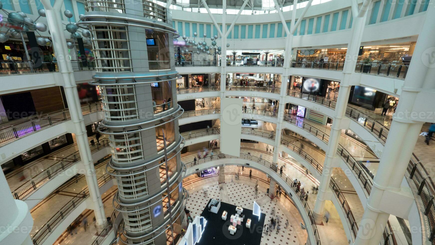 Multistorey shopping mall with customers photo