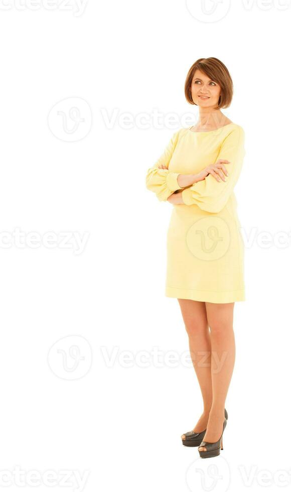 Adult woman in yellow dress looking up photo