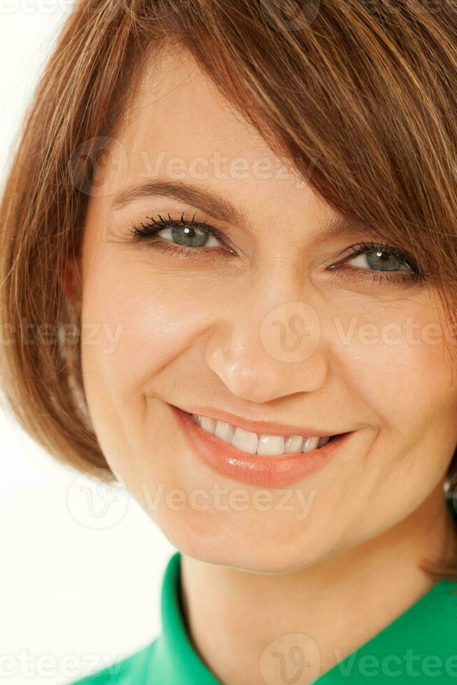 Close-up of beautiful adult woman smiling at camera photo