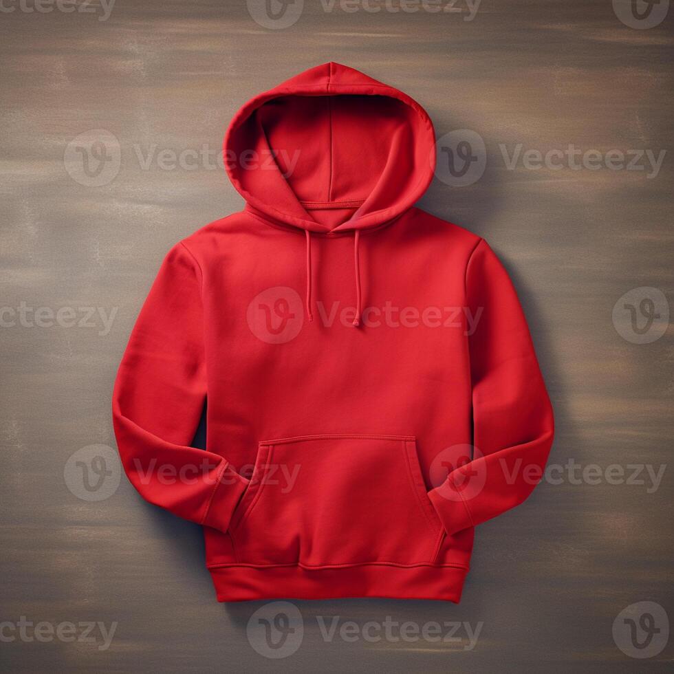Blank red hoodie lying on the table, photographed from above photo