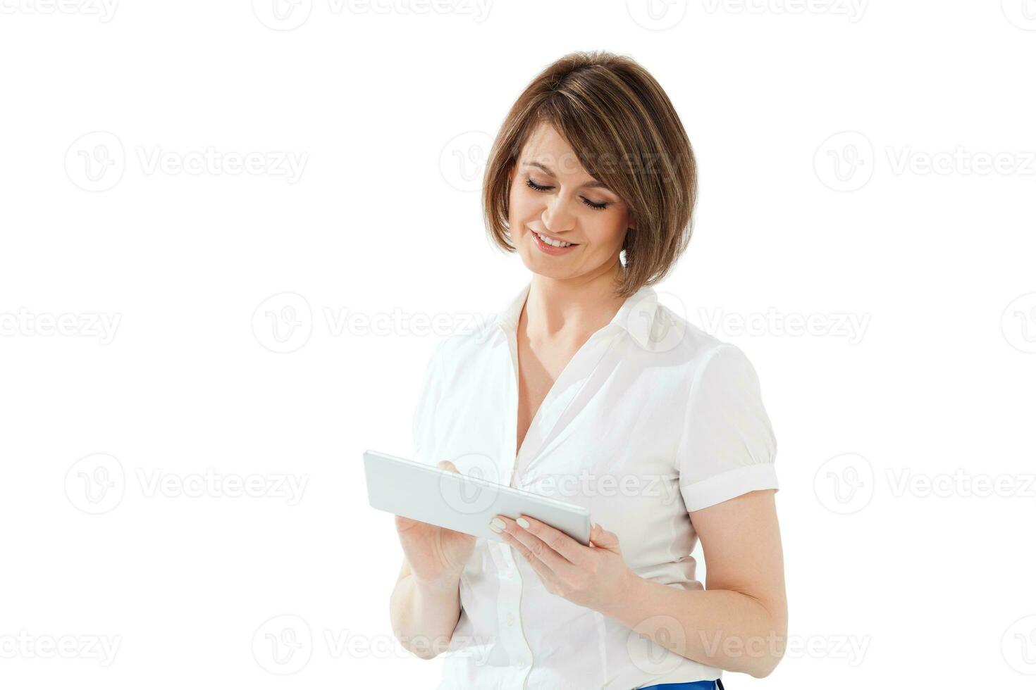 Smiling adult woman using tablet photo