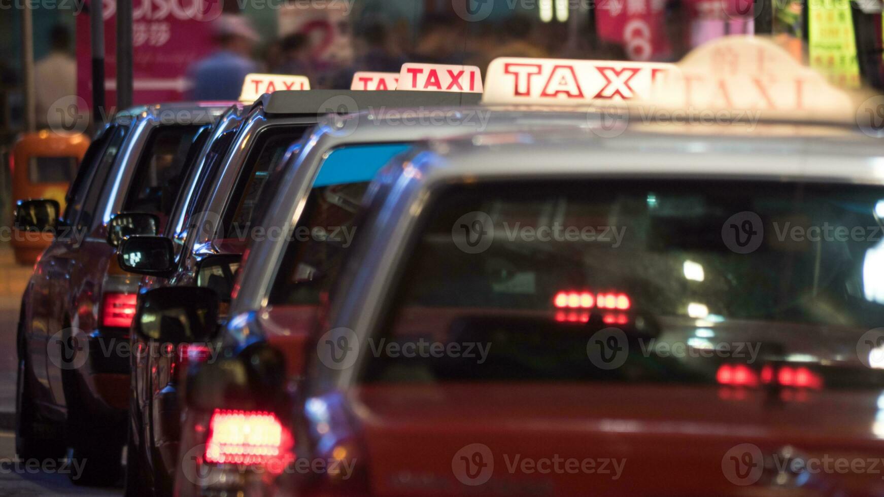 Taxi cars parked in row at night photo