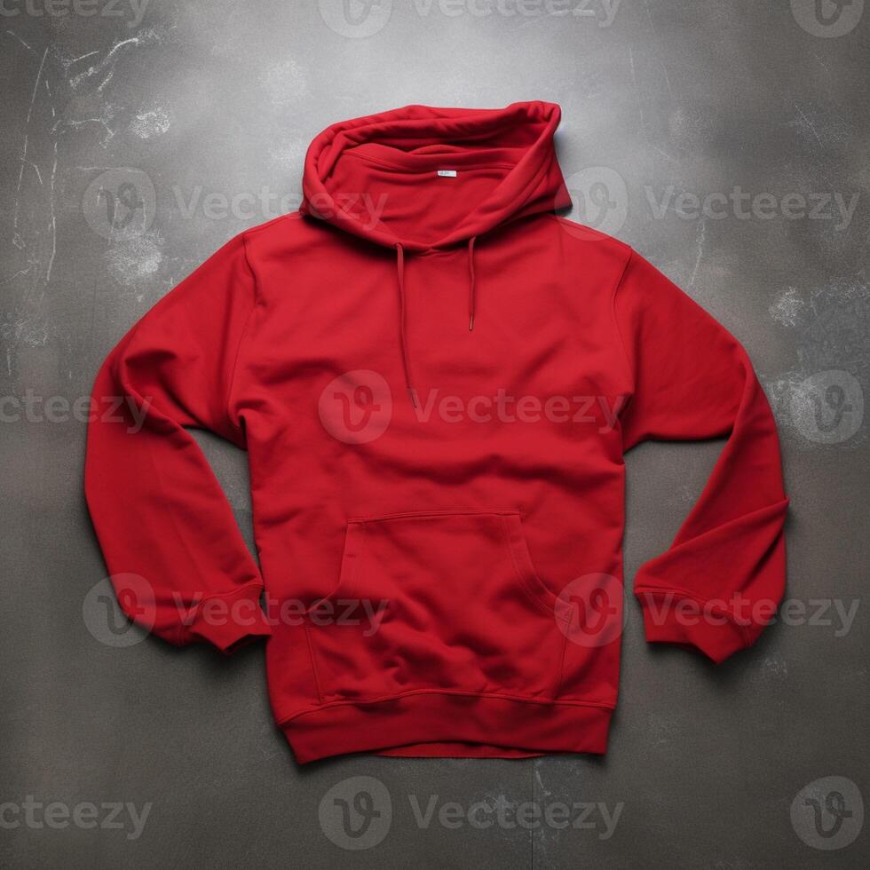Blank red hoodie lying on the table, photographed from above photo