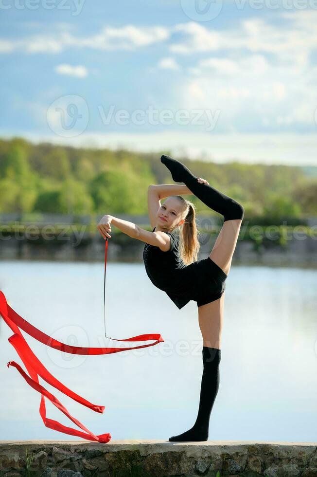 Rhythmic Gymnast in Vertical Split with Ribbon photo