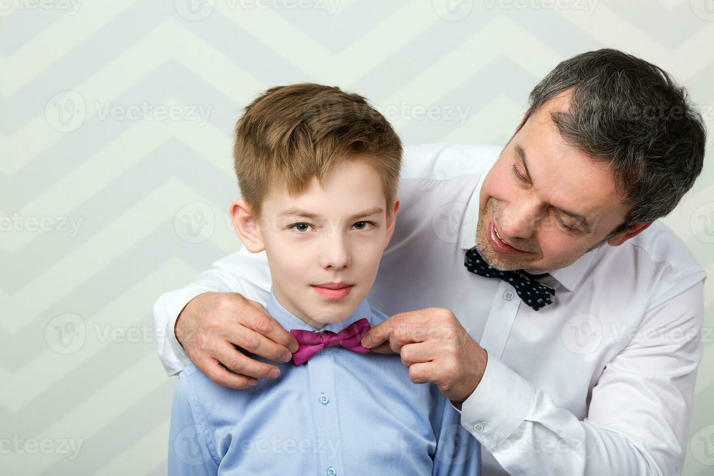 Father adjusting sons bowtie photo