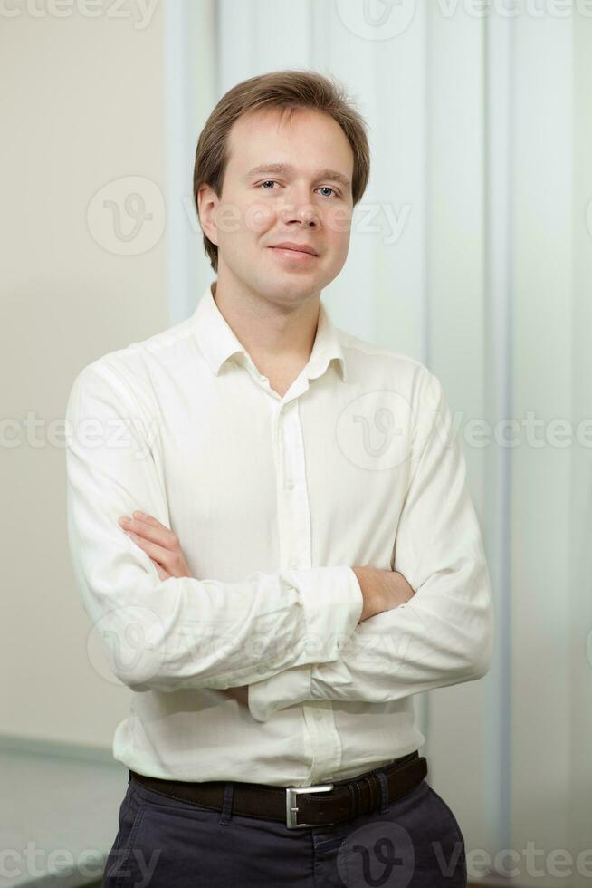 Portrait of young confident man indoor photo