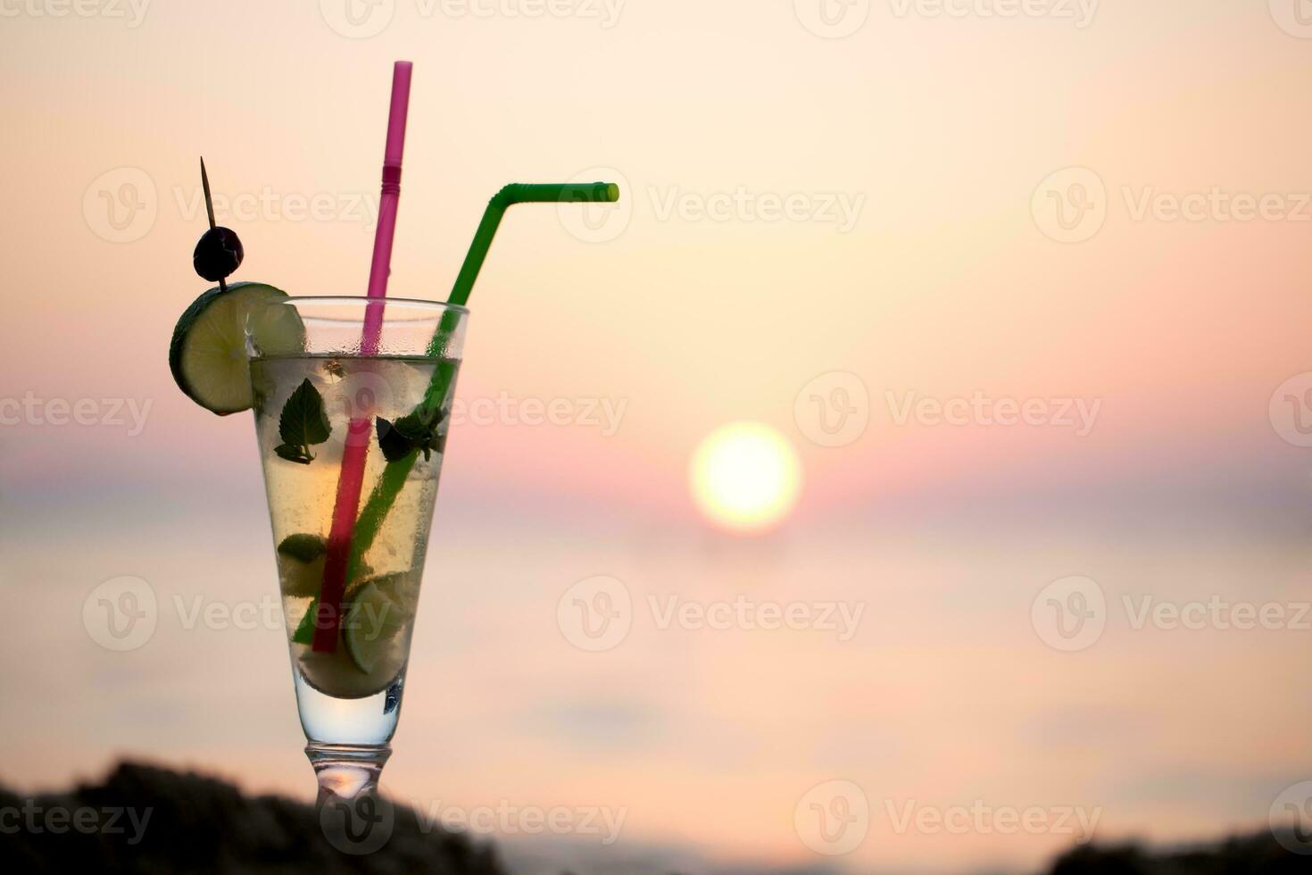 Mojito cocktail on the beach at sunset photo