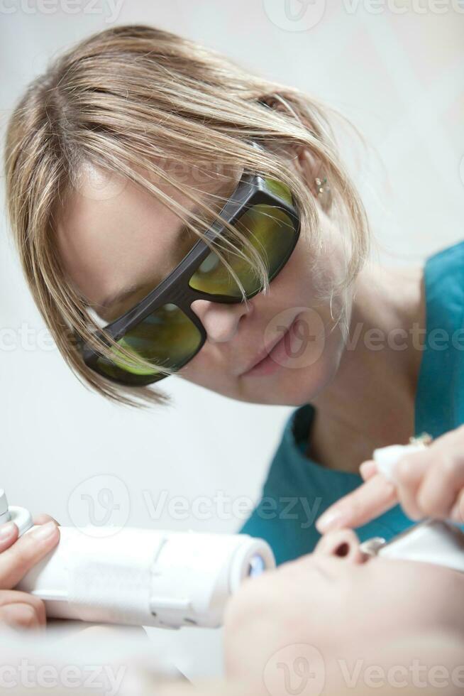 Laser facial treatment in cosmetology clinic photo