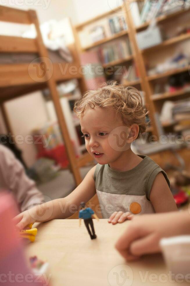 Little boy playing with toys in the room photo